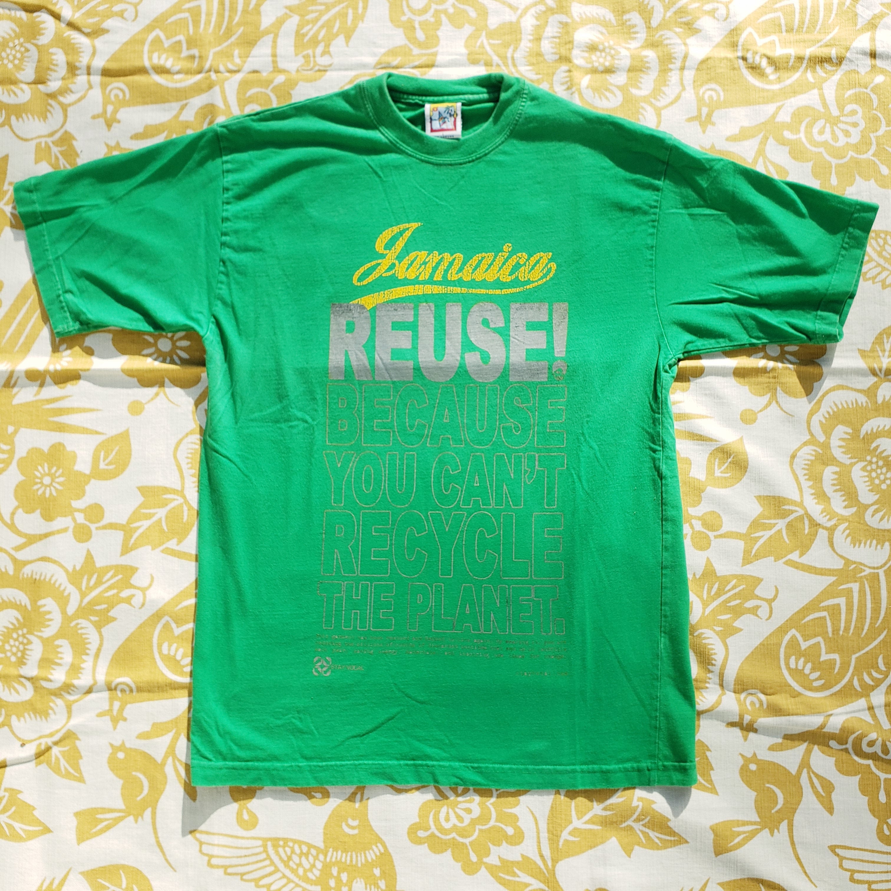 Eco friendly upcycled green Jamaica T-Shirt that says Reuse Because You Can't Recycle The Planet.