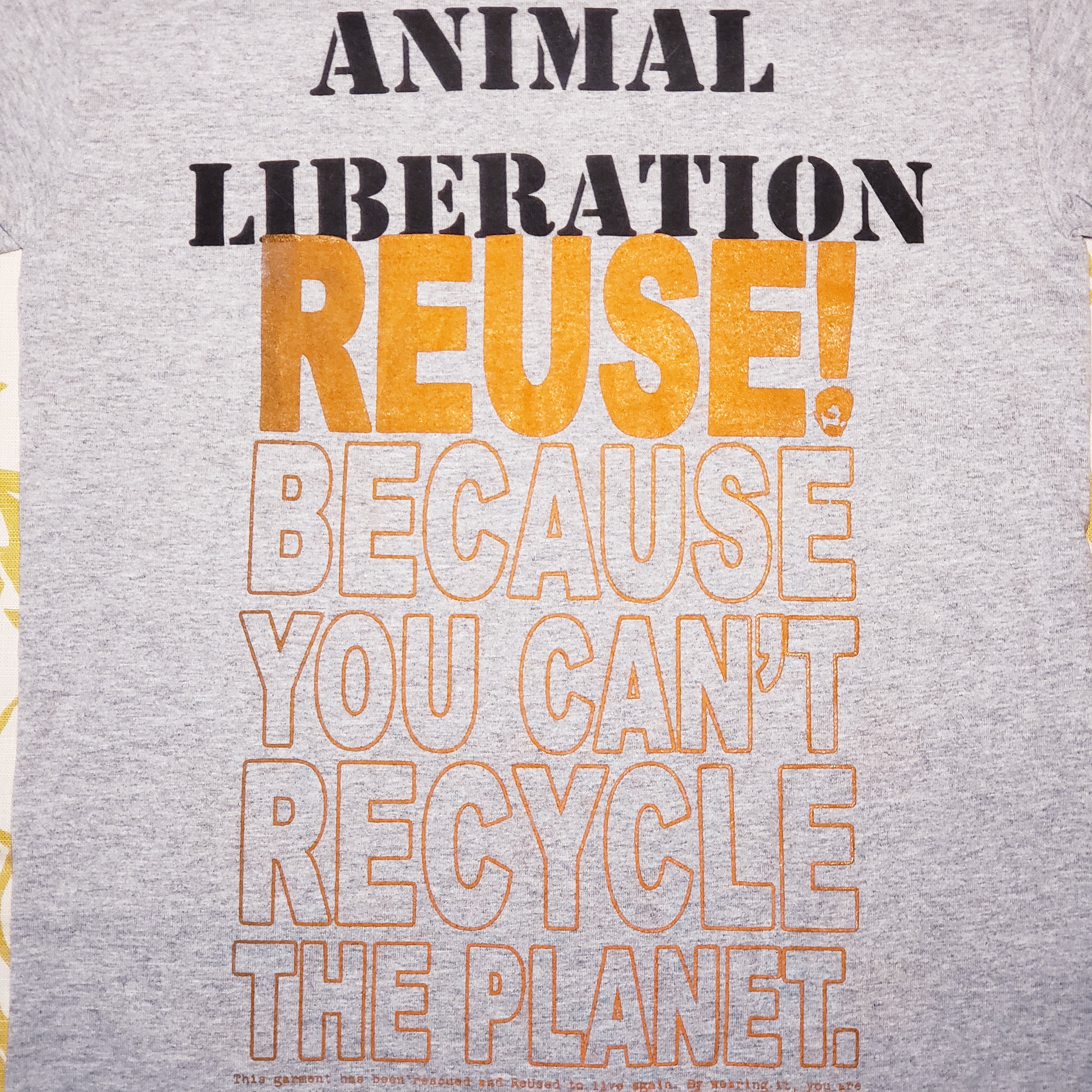 Eco friendly upcycled Animal Liberation T-Shirt that says Reuse Because You Can't Recycle The Planet.
